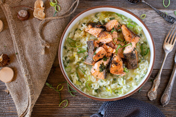 Risotto with leek and cheese served with fried salmon fillet