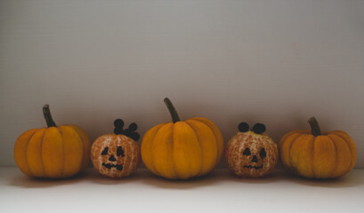 Halloween background presented by pumpkins and tangerines on the white background