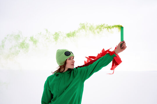 Woman holding distress flare in air against sky