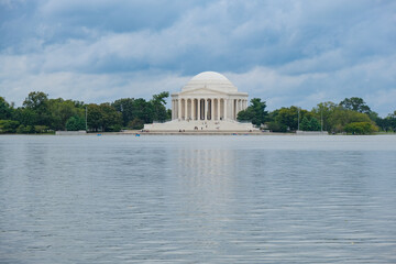 Jefferson Memorial landmark hall, a presidential memorial site built in Washington, D.C. at Tidal Basin Lake with picturesque cherry tree nature landscape with columns and dome and statue
