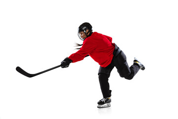 Full-length portrait of professional female hockey player training in special uniform with helmet...