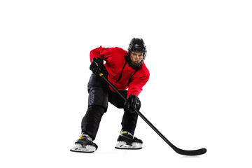 Full-length portrait of woman, professional hockey player training isolated over white background....