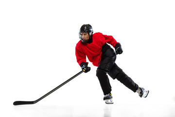 Full-length portrait of professional female hockey player training isolated over white background....