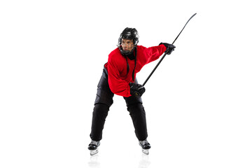 Full-length portrait of woman, professional hockey player in motion with raised stick, training...