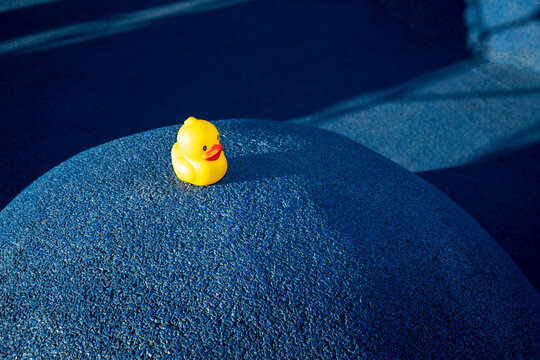 Yellow rubber duck on blue structure at skateboard park