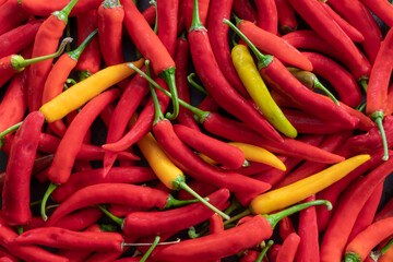 Background from jumbled ripe red and yellow pepperonis
