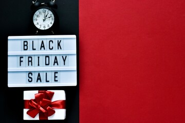 Creative composition. BLACK FRIDAY SALE text on lightbox, alarm clock and gift box on a red and black background. Copy space. Square Template, Black friday sale, mockup fall thanksgiving 