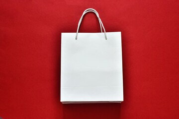 Black Friday sale. Black Friday sale shopping. White paper shopping bag on a red background. Flat...