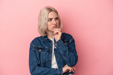 Young caucasian woman isolated on pink background suffers pain in throat due a virus or infection.