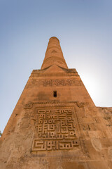 Fototapeta na wymiar Limestone Arab minaret with bas-reliefs in South East Turkey