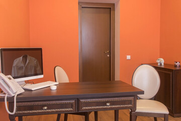 Interior design of a doctor's office with a wooden table, a pair of chairs, a workplace with a...