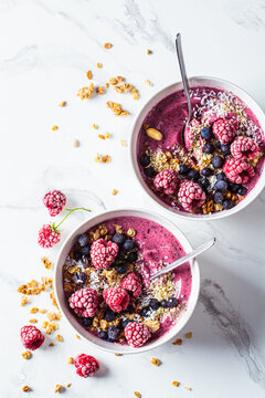 Berry Smoothie Bowl With Granola, Coconut And Hemp Seeds, Marble Background. Vegan Food Concept.