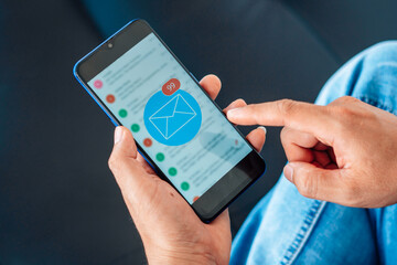 Email concept, Closeup Woman hand using mobile smartphone with email icon.