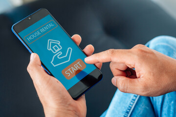 man searching for apartment on rental property website via smartphone, closeup