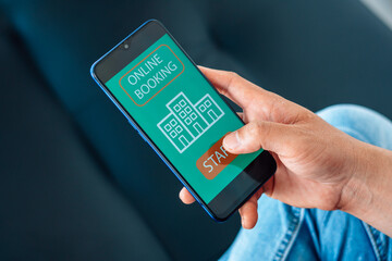 man searching for apartment on rental property website via smartphone, closeup