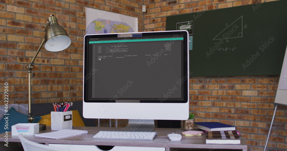 Poster computer screen with data processing standing on desk in office