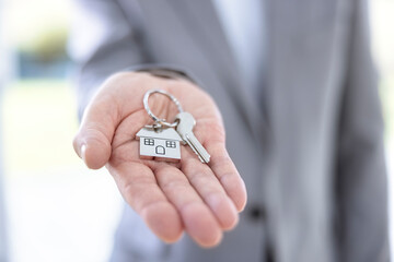 Real estate agent giving house keys