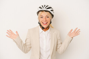 Young business Russian woman holding bike helmet isolated on white background receiving a pleasant surprise, excited and raising hands.