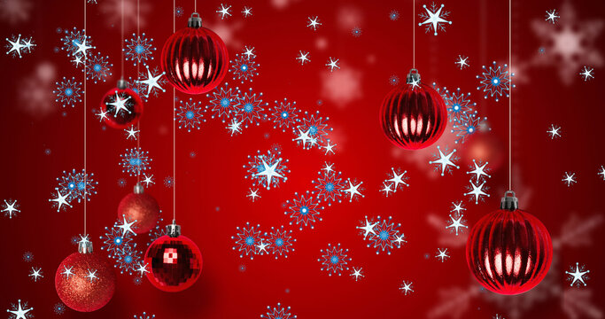 Image of christmas balls over snowflakes on red background