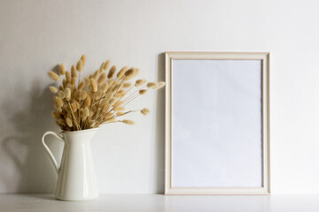 A white photo frame with flowers with nature light. 