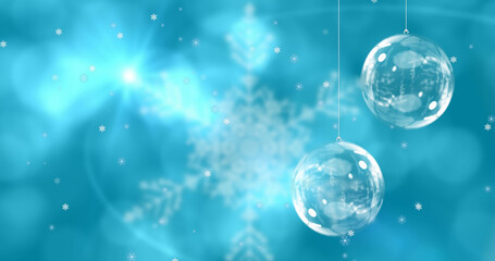 Fototapeta na wymiar Image of christmas balls over snowflakes on blue background
