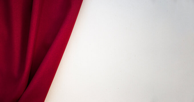 The red curtain is pulled back against a light background. Copy space, place for text