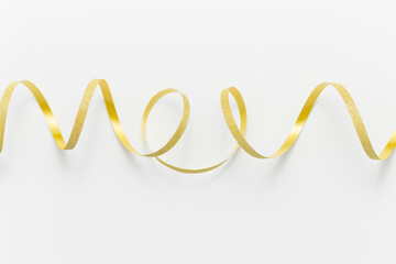 Golden ribbon on white background. New Year and Christmas celebration, winter holidays, events and parties concept