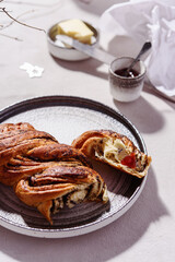 Swirl brioche with poppy seeds served with butter and jam. Poppy seed braided or roll bread, Babka. Traditional sweet Christmas bread