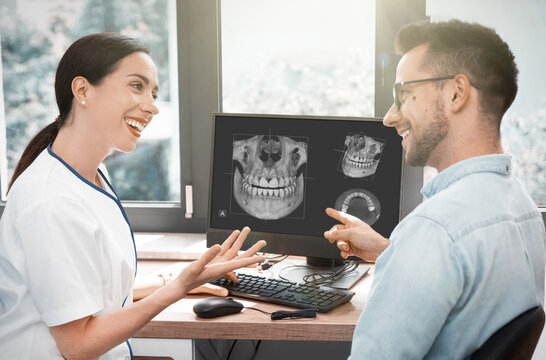 Dentist and patient consultation with x-ray image