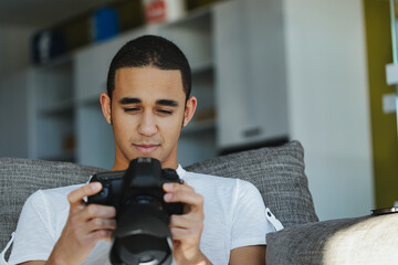 Black male photographer chimping his shot in the viewfinder