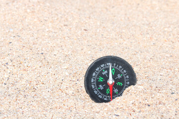 Fototapeta na wymiar Classic navigation compass on beach as symbol of tourism with compass, travel with compass and outdoor activities with compass