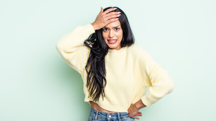 pretty hispanic woman panicking over a forgotten deadline, feeling stressed, having to cover up a...