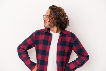 Young caucasian man isolated on white background dreaming of achieving goals and purposes