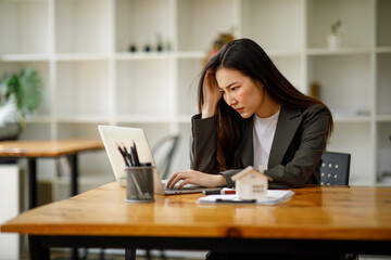 Asian business woman real estate agent home loan working at the office. signs a purchase contract or mortgage for a home, Real estate concept.
