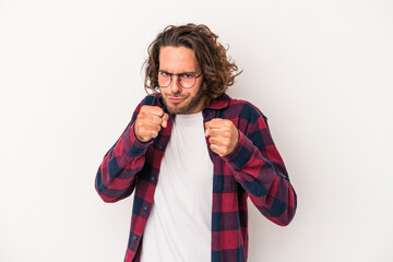 Young caucasian man isolated on white background showing fist to camera, aggressive facial expression.