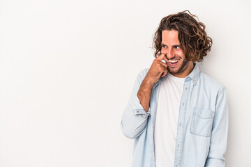 Young caucasian man isolated on white background relaxed thinking about something looking at a copy space.