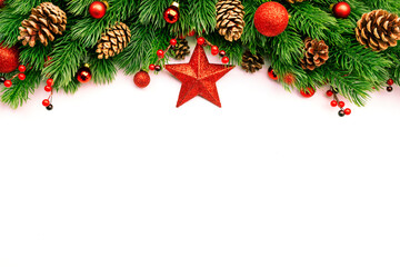 Christmas and New Year background with green spruce branches, cones, balls, star and red berries, white banner, top view, copy space