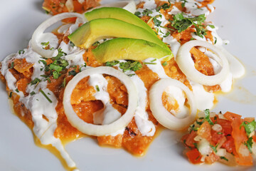 Chilaquiles rojos with avocado,mexican breakfast 
