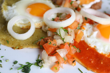 Huevos divorciados, fried eggs on corn tortillas with salsa verde and roja , mexican breakfast