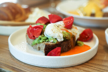 Benedict eggs with tomato and avocado