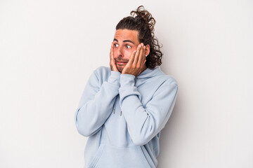 Young caucasian man isolated on gray background scared and afraid.