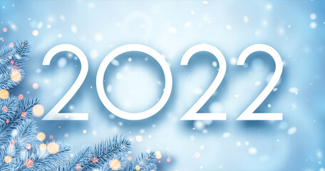 2022 Christmas blue spruce branches with bokeh lights.
