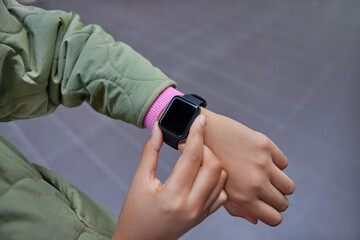 Selective focus of womans arm with smartwatch on wrist. Digital wearable wristwatch with empty...