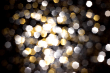 Golden and silver blurred bokeh lights on black background. Glitter sparkle stars for celebrate. Overlay for your design