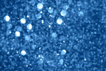 Blue sparkling glitter bokeh background, christmas abstract defocused texture. Holiday lights
