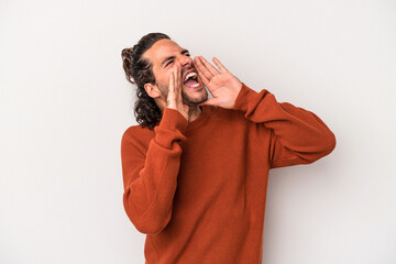 Young caucasian man isolated on gray background shouting excited to front.