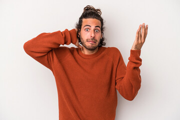 Young caucasian man isolated on gray background screaming with rage.