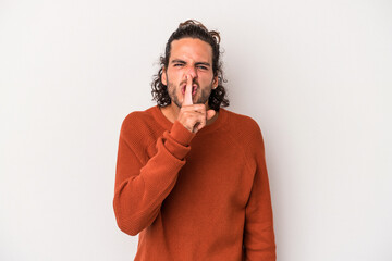 Young caucasian man isolated on gray background keeping a secret or asking for silence.