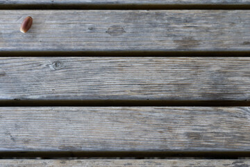 Here's a picture of some wood that can be used as a background, with an acorn placed in the upper left corner.