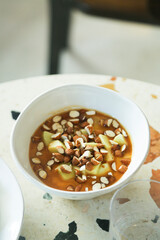 Delicious apple porridge with caramel sauce and almond